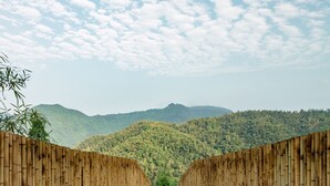 A bamboo structure with a view of a forested mountain range. - Origin Villa Hotel (Hangzhou)
