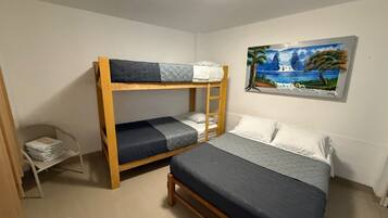Habitación con literas y un cuadro de un paisaje en la pared.