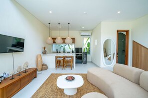 Deluxe Villa, Patio, Pool View | Living area