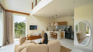 Deluxe Villa, Patio, Pool View | Living room | 42-inch flat-screen TV with cable channels