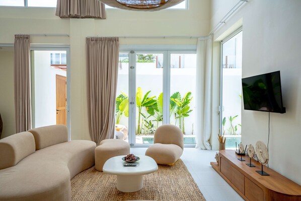 Deluxe Villa, Patio, Pool View | Living area