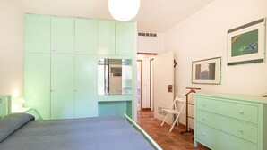 A bedroom with a bed, a wardrobe, a dresser, and a chair. - Alessia, three-room apartment in Marina di Campo 250 meters from the beach, with air conditioning, p (Marina di Campo)