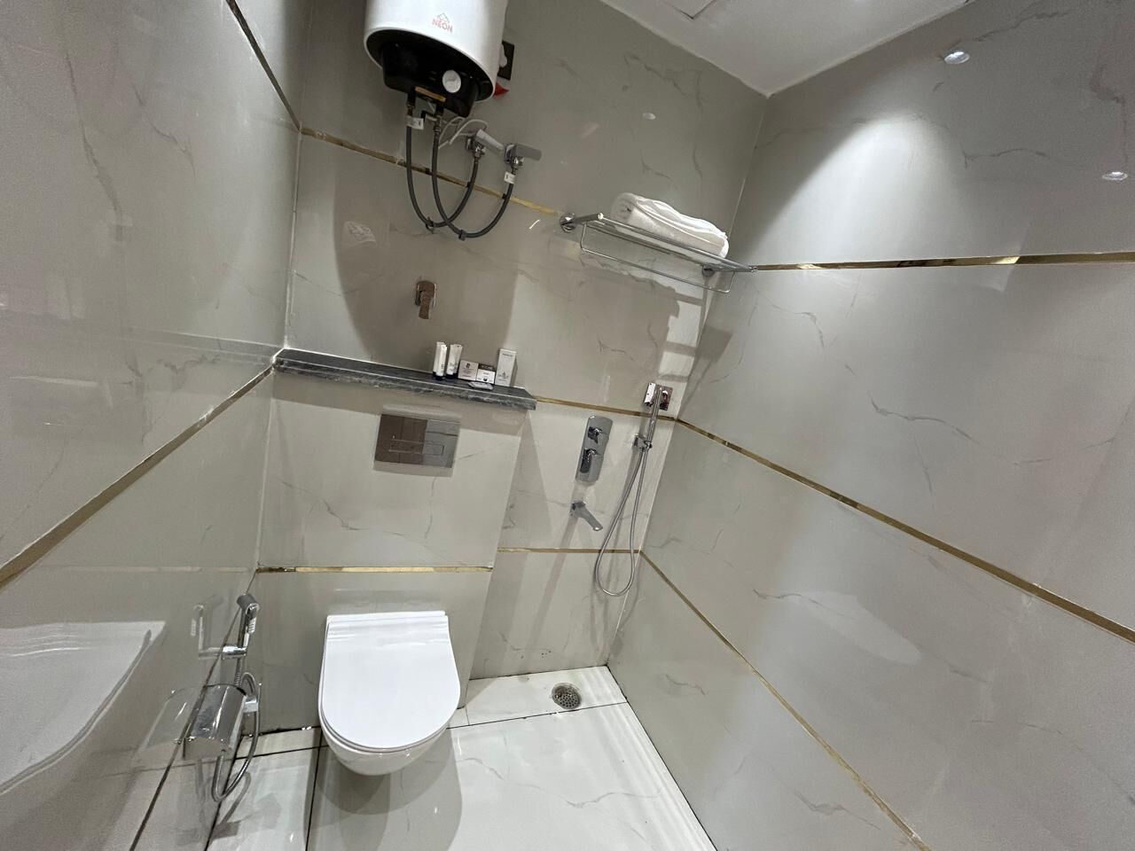 A modern bathroom with a toilet, sink, and shower.