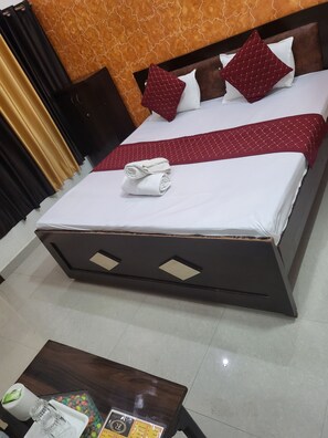 Relax in comfort with a large bed, a small table, and a stylish bathroom.