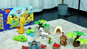 A play area with a LEGO set, a potted plant, and a toy vehicle.