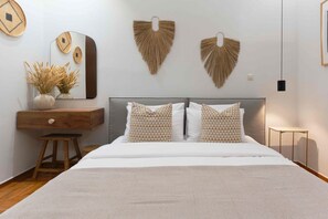 Een slaapkamer met een bed, een dressoir, een spiegel en wanddecoratie.