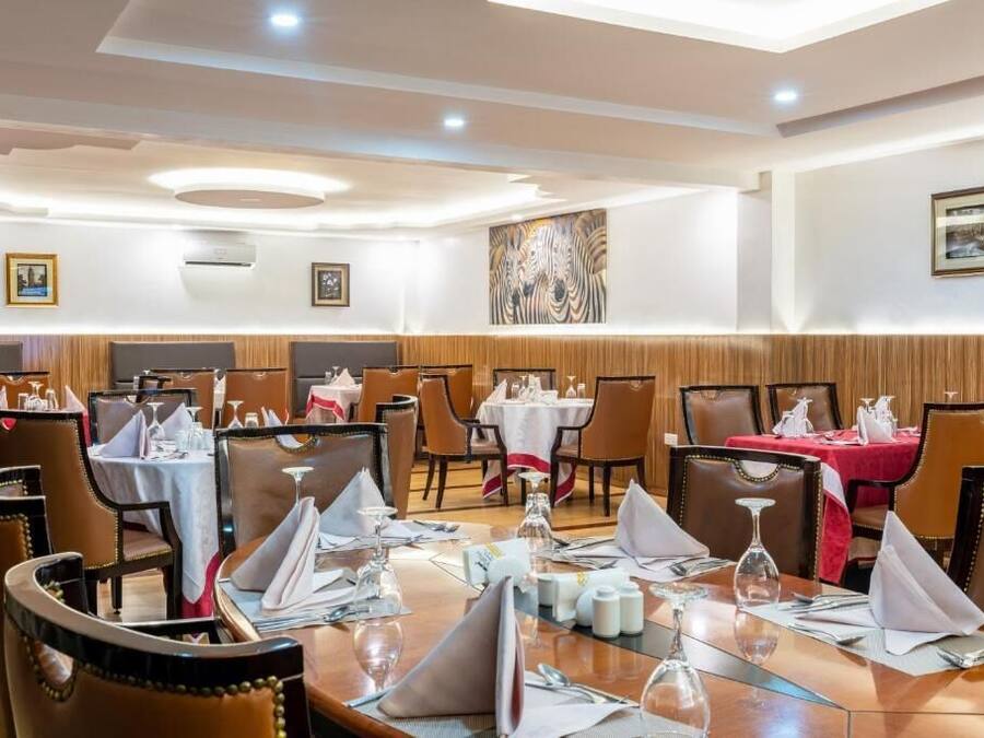 A restaurant with multiple tables set for dining, featuring a mix of booth and standard table seating.