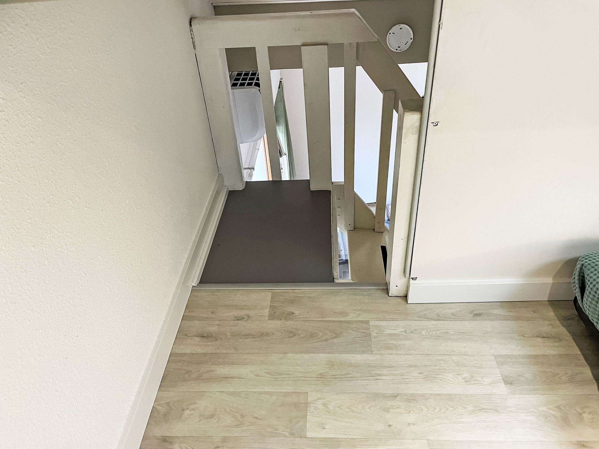 A staircase with a wooden floor leading to a landing.