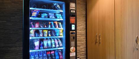 A vending machine stocked with snacks, drinks, and personal care items.