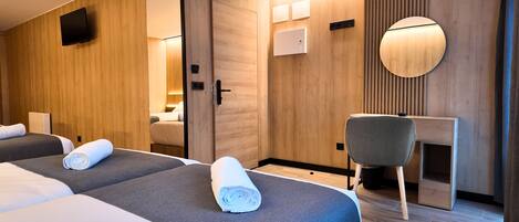 Premium bedding, memory-foam beds, desk, laptop workspace