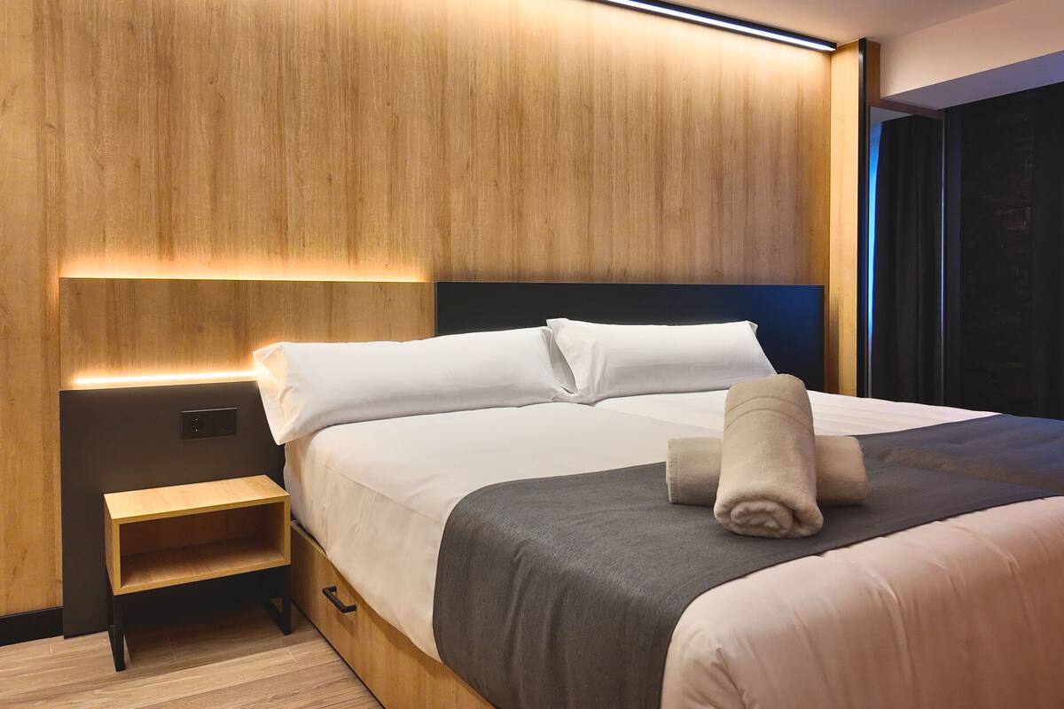 Premium bedding, memory-foam beds, desk, laptop workspace