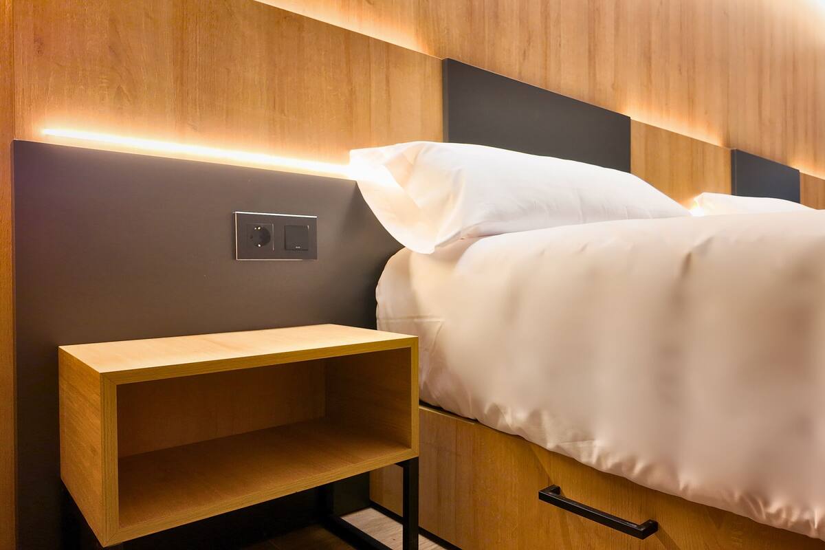 Premium bedding, memory-foam beds, desk, laptop workspace