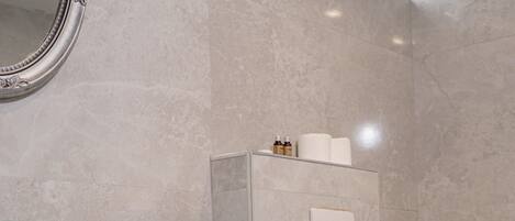 A bathroom with a white sink, a toilet, and a mirror with an ornate frame.