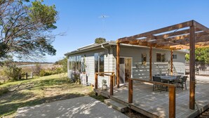 A house with a wooden deck, a covered patio, and a view of a lake. - Pelican Point- Located next to Edwards Point Wildlife Reserve (St Leonards)