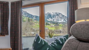 A room with a view of mountains and a small village. - Alpine Mountain Chalet (Marebbe)