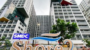 Une enseigne pour SMDC Shore2, avec un bâtiment moderne en arrière-plan.