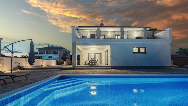 A modern two-story house with a swimming pool in the foreground. - Enchanting Villa North with Pool and Jacuzzi (Krnica)
