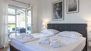 A hotel room with two beds, a balcony, and artwork on the wall. - Villa with pool in Istria for 8 persons, with a wonderful panoramic view  (Vižinada)