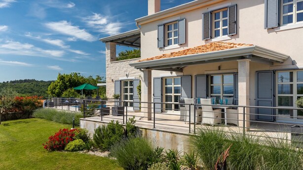 A two-story house with a balcony, large windows, and a stone facade. - Villa with pool in Istria for 8 persons, with a wonderful panoramic view  (Vižinada)