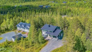 A large lodge with multiple buildings surrounded by dense forest. - Rukan tunturituuli by Interhome (Kuusamo)