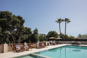A swimming pool with lounge chairs and umbrellas, surrounded by trees and a fence. - Riviera Vista Luxury Homes -  Hydramis, w/shared Pool (9829+99H Lappei, Greece)