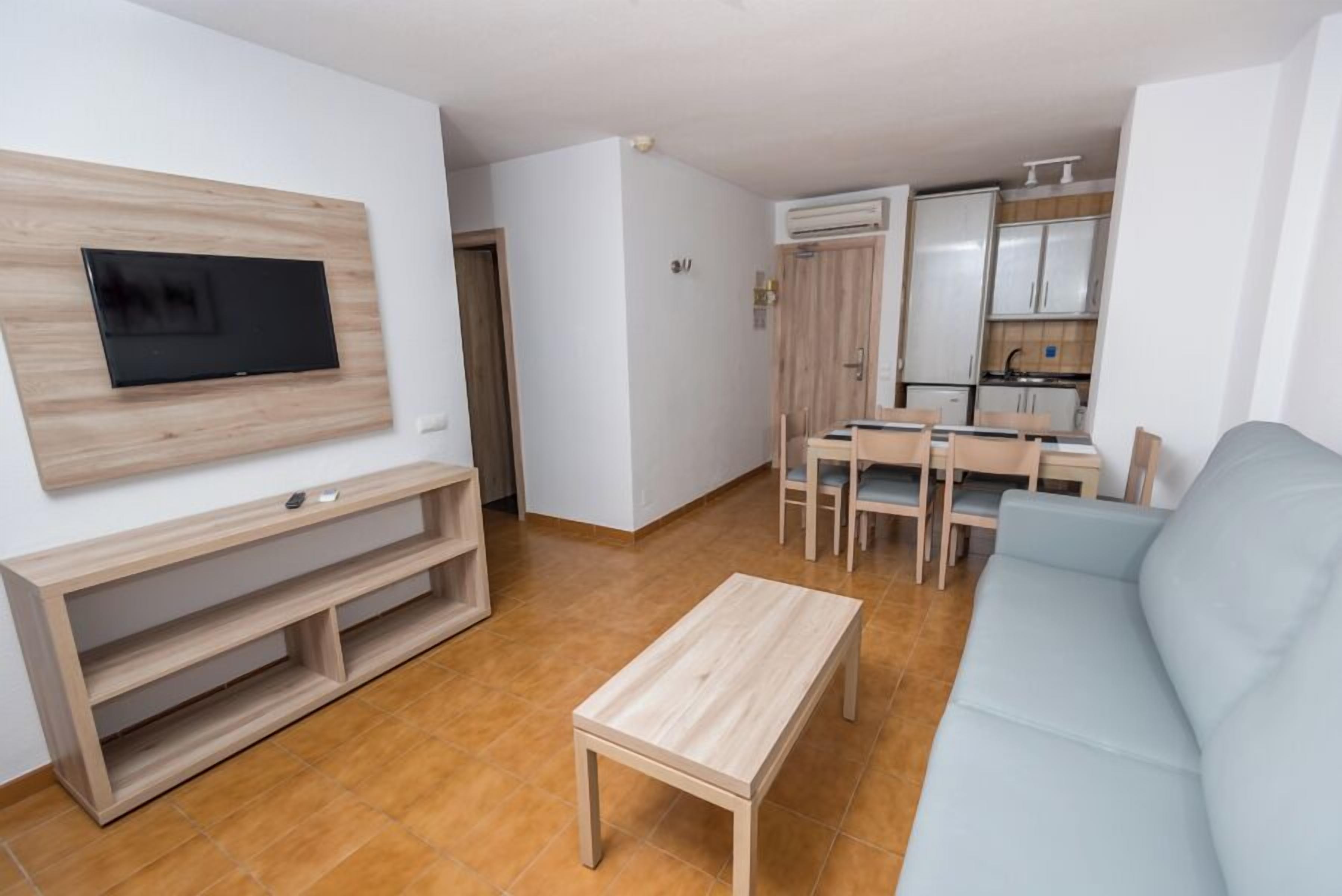 Classic Apartment, Balcony | Living area | 84-inch flat-screen TV with digital channels