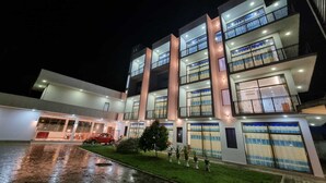 A multi-story hotel with a modern design, featuring balconies with decorative railings and a spacious entrance area. - Utopia Polhena Hotel (Matara)
