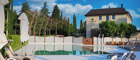 Seasonal outdoor pool, open 10:00 AM to 7:00 PM, pool umbrellas