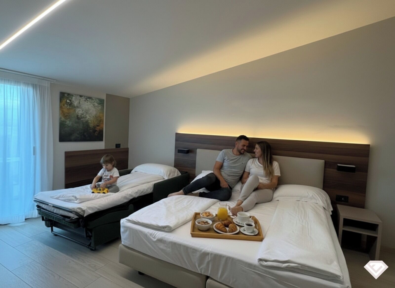 A hotel room with two beds, a breakfast tray with croissants, and a child playing with a toy.