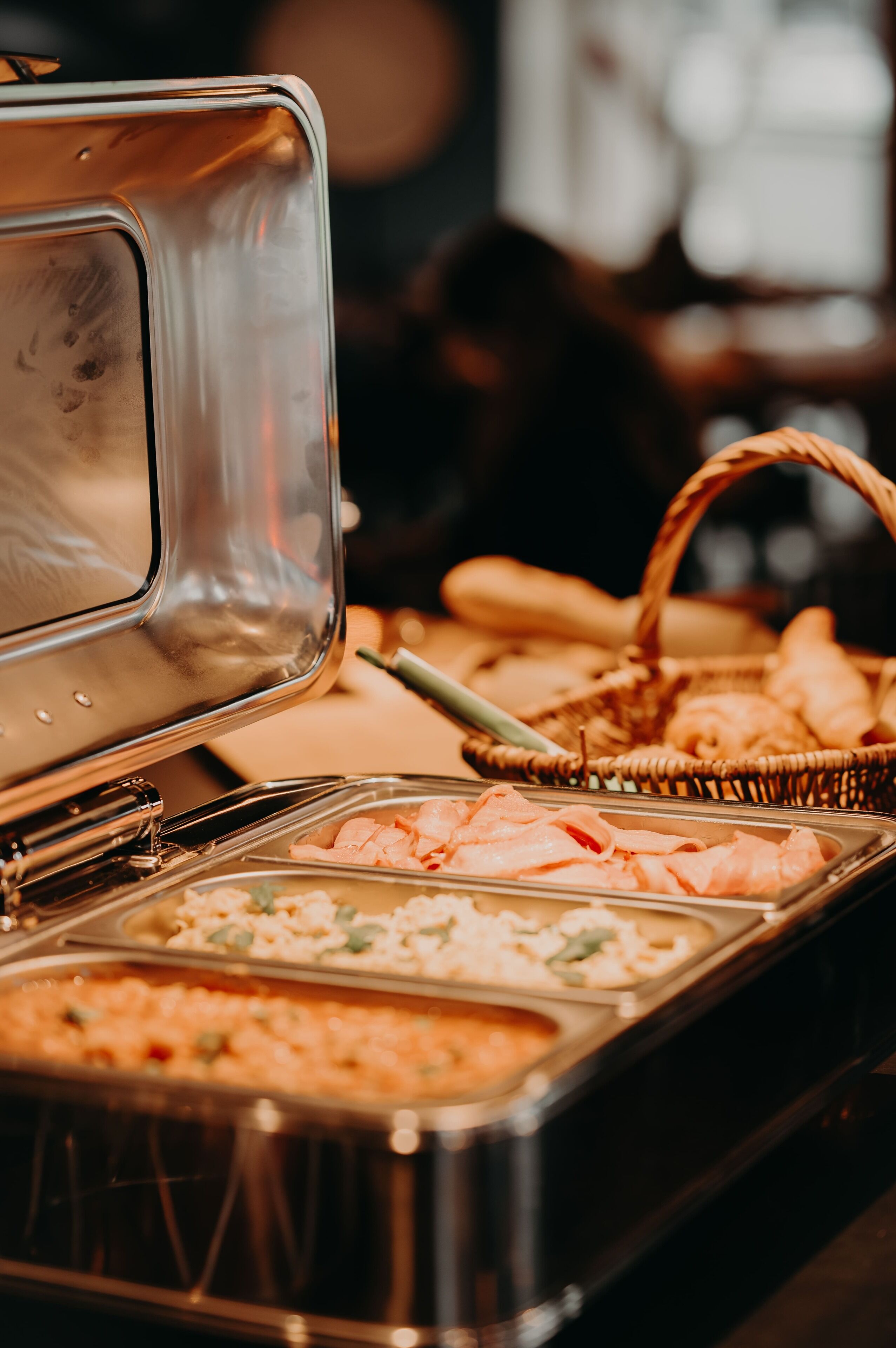 A buffet with various food items including shrimp, bread, and pastries.