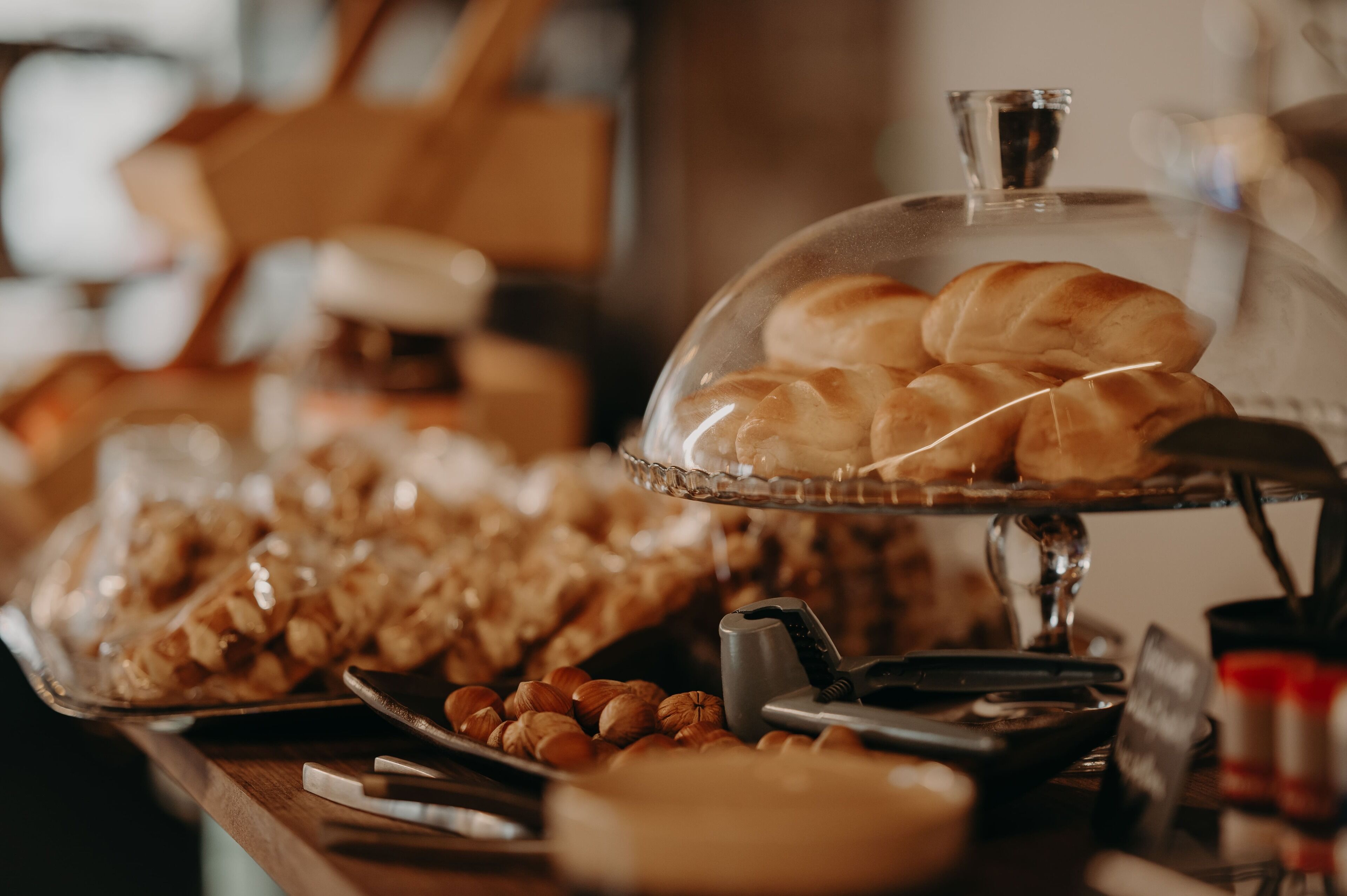 A buffet table with various baked goods and nuts.