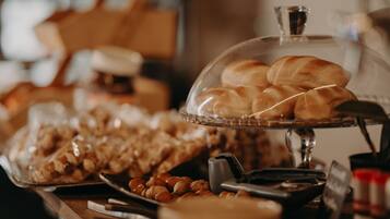 A buffet table with various baked goods and nuts.