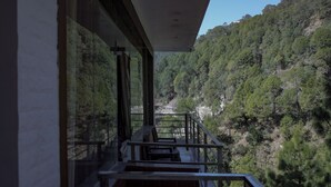 A balcony with a view of a forested valley. - The White Rain Hotel (Lansdowne)