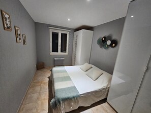 A bedroom with a bed, wardrobe, and a window. - 200 m² Villa, Sleeps 8, 4 Bedrooms, Swimming Pool, Provence, Ventoux (Mazan)