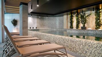 Relax by the pool surrounded by lush greenery and modern decor.