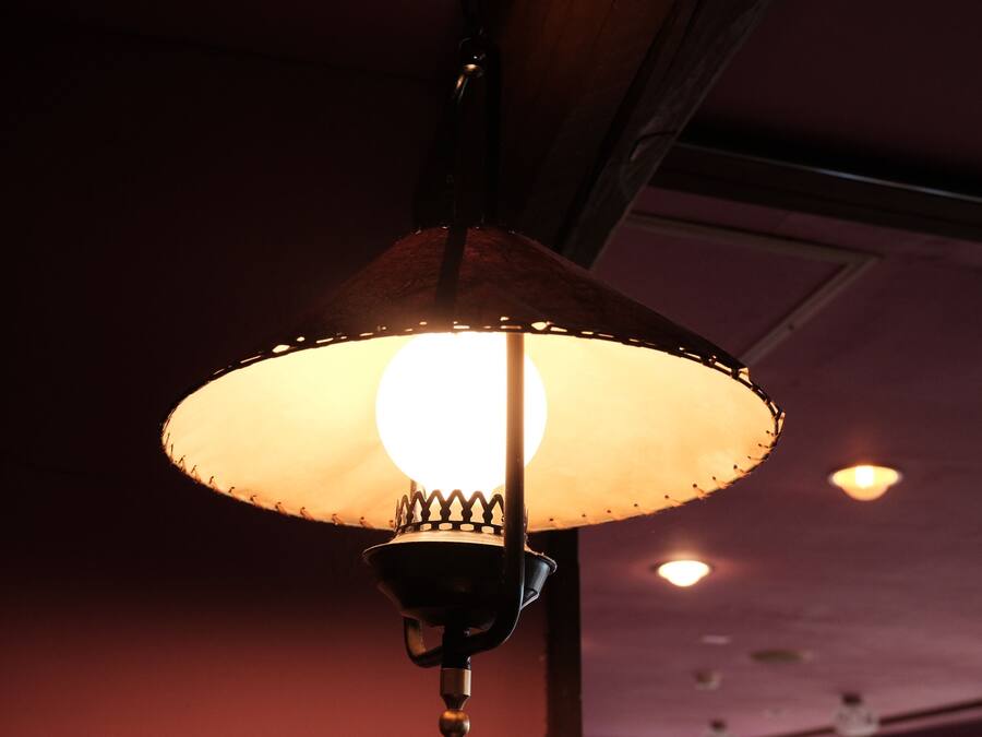 A hanging lamp with a conical shade and a visible bulb.