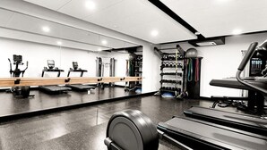 A gym with treadmills, elliptical machines, and weightlifting equipment. - Landing | Incredible Studio, Game Room, Gym (Salt Lake City)