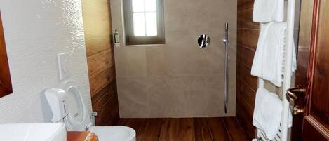 A bathroom with a shower, toilet, and sink.