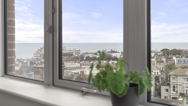 A window with a view of a cityscape and a body of water. - Ocean View E By My Getaways (St Leonards-On-Sea)