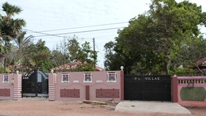A gated entrance with a sign reading "PETER LAWRENCE" and "P.L. VILLAS". - Plvillas (Pesalai)