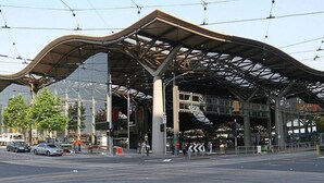 A modern bus station with a curved roof and large glass windows. - Spacious 2BR Apartment with Extra Sleeping Space (Melbourne)