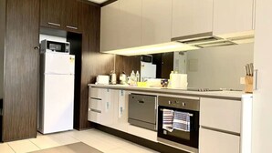 A modern kitchen with a built-in microwave, refrigerator, oven, and dishwasher. - Lonsdale Heights (Higher Floor) 1BR with City View (Melbourne)