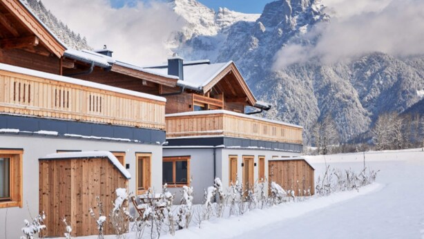 A wooden chalet with a balcony, set against a snowy mountain backdrop. - Chalet in Alps Near Ski Lift & Slope (St. Ulrich Am Pillersee)