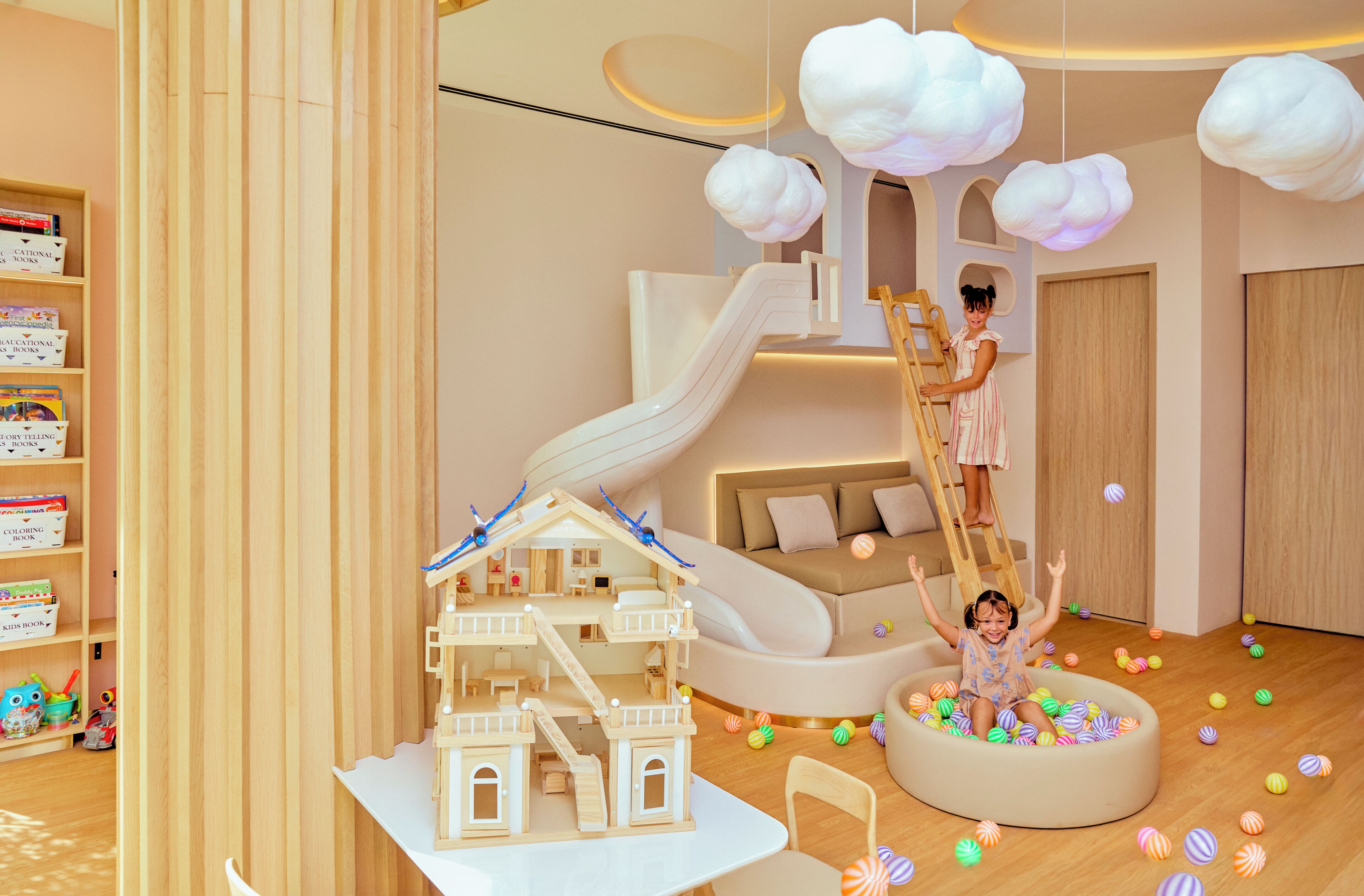 A children's play area with a slide, a climbing structure, and a ball pit.
