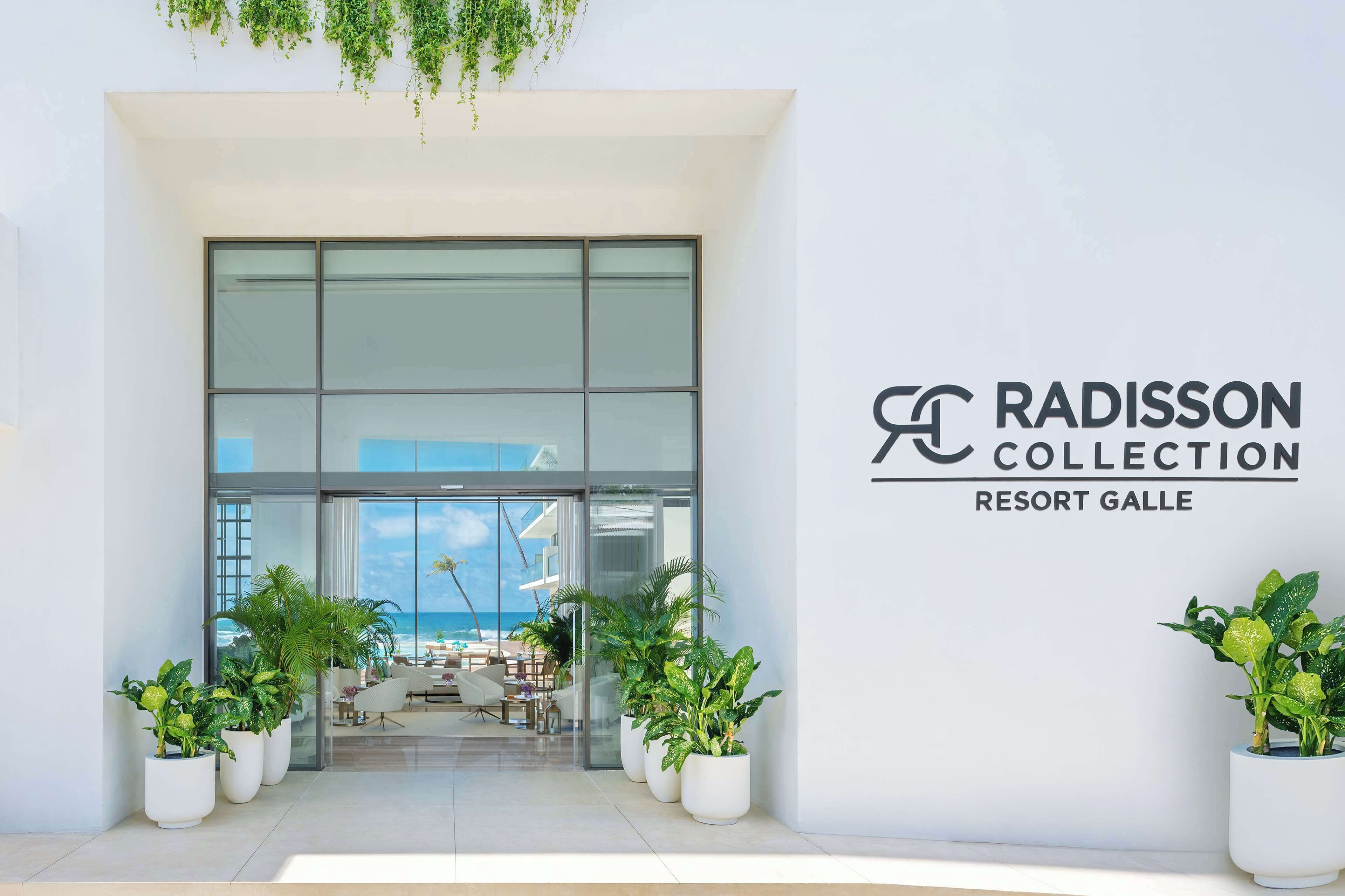 The entrance to Radisson Collection Resort Galle with a view of the beach and outdoor seating area.