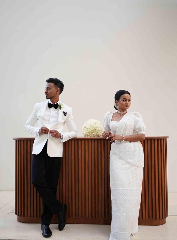 A man and a woman standing at a wooden podium with a floral arrangement. - Radisson Collection Resort & Spa, Galle (Talpe)