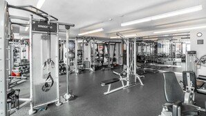 A gym with various exercise equipment, including weight machines and free weights. - *New* *Modern* Less than 2 Miles from Universal, Epic Univ, Volcano Bay & More (Orlando)