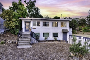 A two-story house with a front porch, a staircase, and a picket fence. - Timeless Charm, Modern Comfort close to everything (Sonoma)