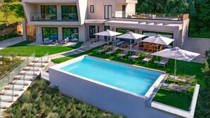 A modern two-story house with a swimming pool, outdoor seating, and a well-maintained garden. - Villa Optima by Villa Plus (Ionian Islands)