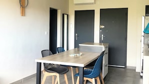 A modern kitchen with a dining area.